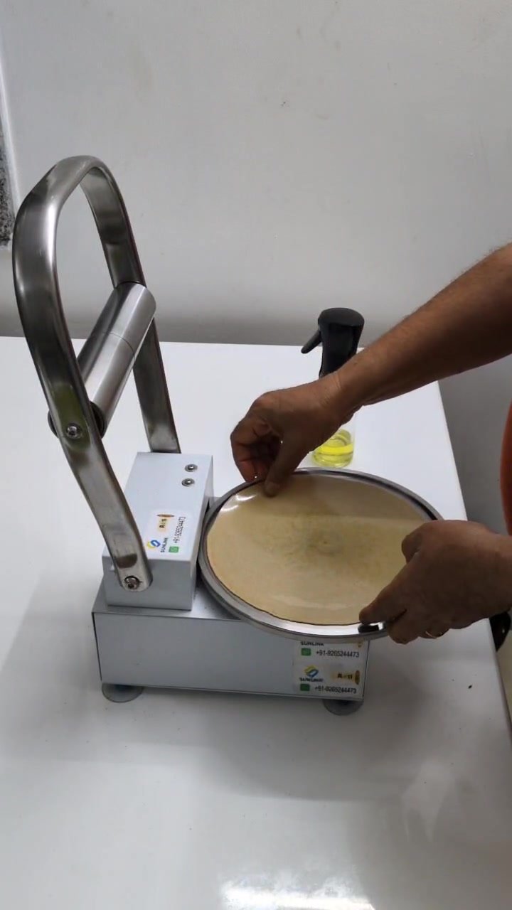 RotiMitra Remove Sheets Demo Removing the sheet from pressed dough on the RotiMitra machine